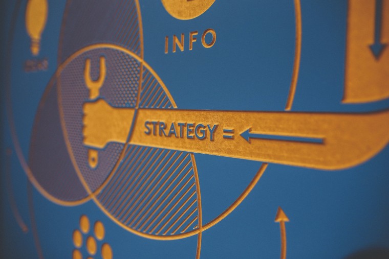 A close-up of a diagram with the word strategy and directional arrows